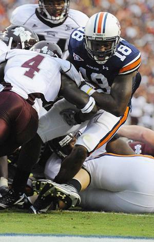 Auburn's Kodi Burns (Fort Smith Northside) scores a touchdown in Saturday's 49-24 victory over Mississippi State. Burns ran for three touchdowns and passed for another as quarterback in the Wildcat formation.