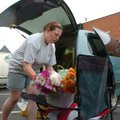 <b>Wet interruption</b>
Deana Dickey, with Dickey Farms in Tontitown, picks up her booth at the Fay...