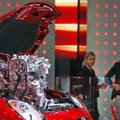Visitors look at an Alfa Romeo on display Wednesday at the Frankfurt Auto Show in Frankfurt, Germany...