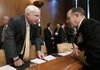 Sen. John McCain (left), ranking Republican on the Senate Armed Services Committee, talks with Adm. Michael Mullen before the chairman of the Joint Chiefs of Staff's testimony Tuesday.
