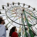 Vince Campbell, 38, of Mountain Home, Ark., and his sister, Ronda Bowden, 43, look over a Ferris whe...