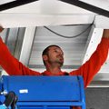 James Phillips with Multi-Craft Construction finished putting up the ceiling on the awning covering ...