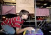  Joseph Brandeberry, 12, played a computer game during his downtime at the Benton County Fair on Wednesday.