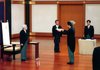 Yukio Hatoyama accepts a certificate Wednesday from Japan's Emperor Akihito (left) in his installation as prime minister at the Imperial Palace in Tokyo. Hatoyama's predecessor, Taro Aso, witnesses the ceremony.
