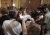A Senate aide hands out copies of the health-care proposal Wednesday before a news conference by Senate Finance Committee Chairman Max Baucus of Montana.