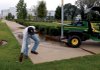 Eddie Woods of Sundial Construction picks up trash at the Clinton Presidential Park on Thursday afternoon. The William J. Clinton Foundation pays Sundial to help maintain the grounds. 