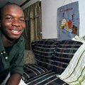 Emmanuel Dorko is shown at his home in Siloam Springs with a handmade map of his country and a triba...