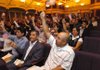 Rena Aleala, right, and about 70 other new American citizens wave flags in celebration Thursday at the Jones Center for Families during a naturalization ceremony. People from about 10 countries received their citizenship Thursday during the ceremony. 

