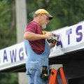 <b>Dawg Treats</b>
Lew Indorf, a worker with Ken's Signs Inc., secures a newly fashioned sign that ...