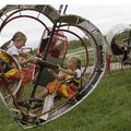Malia Blevins (left) , 8, of Lowell and her sister Lindi, 6, ride the Heart Flip at the Benton Count...