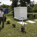 Richard Cox of Lowell, a member of the National Ghost Rider Association, installs lights around the ...