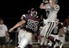 Siloam Springs junior receiver Greg Frabotta came down with a catch in front of Gentry junior linebacker Eathen Ramsey during the second quarter of Friday night's game at Pioneer Stadium in Gentry.