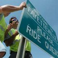 Kevin Henson, left, and Mike Prater, with the City of Fayetteville's Transportation Department, hang...