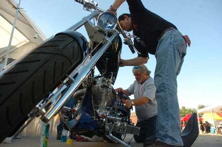 
                               
                                  Photo by Anthony Reyes&mdash;
                               
                           
                           Kevin Williams, right, owner of Hawg City Choppers in Fayetteville, and friend Mike Kugler polish a custom built motorcycle Thursday, Oct. 4, 2007 at Bikes Blues and BBQ. The chopper, built by Williams' business partner John Hill, was on display to show the companies work at the booth near the Tyson Indoor Track Center.