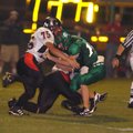 Pea Ridge junior Kirk Parmenter (75) and sophomore Ricardo Schneider (11) sack Greenland quarterback...
