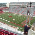 Gareth Clary, with Skycam ESPN, helps install a flying support wire for the Skycam on Friday at Razo...