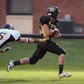 West Fork senior running back Garret Eakins (25) slips from the grasp of Prairie Grove junior Charle...