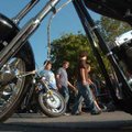 Pedestrians wander through a vendor area North of Dickson Street Saturday during the 2008 Bikes, Blu...