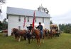 Re-enactors gather Saturday at the Old Yell Lodge in Carrollton before a parade into town. Fifteen orphaned children 150 years ago
spent their first night back in Carrollton at the lodge, which has since burned and been replaced by the current building.