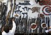 A Pakistani police officer sorts weapons confiscated from a private
security firm during a raid Saturday in Islamabad.
