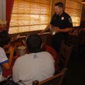 Fayetteville Police Sgt. Paul Shepard, right, and Cpl. Travis Lee talk to Scott Hamilton and his son...