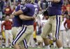 Washington kicker Erik Folk and holder Ronnie Fouch celebrate with teammate Romeo Savant after defeating Southern California on Saturday. The victory propelled Washington into the AP Top 25 for the first time since 2003. The Huskies are ranked No. 24.