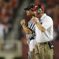 Arkansas coach Bobby Petrino speaks to a game official during the Hogs' 52-41 loss to Georgia Saturd...