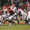  Arkansas sophomore running back Broderick Green, center, is tackled for a loss by Georgia senior de...