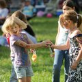 Jaden Jackson, 7, left, laughs as friend, Natalie Ricarte, 8, both of Mountainburg, sprays her with ...