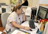 Maria Zamarripa, a health-services specialist, answered phones and made appointments during the grand opening of the Benton County Health Department's new satellite office in Siloam Springs on Monday. 