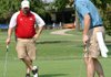 Dale Reed, right, putts in on No. 5 as partner Chad Reaves looks on Monday during the Washington Regional Medical Center tournament at Paradise Valley in Fayetteville. 
 