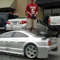 Dylan Woodcock from Springdale, drives his TC4 remote control race car around the parking lot in fro...