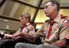 Michael Swisher, 18, of Bentonville sat with his dad, Brian, before Michael was awarded his Eagle Scout badge at St. Stephen Catholic Church in Bentonville on Monday night. Michael was diagnosed with cerebral palsy when he was a baby, and though he has spent his life confined to a wheelchair, he was able to earn his Eagle Scout rank.
