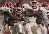Arkansas running back Michael Smith is dragged down by Georgia's Darryl Gamble (50) and Prince Miller (23) in the Bulldogs' 52-41 victory at Reynolds Razorback Stadium in Fayetteville on Saturday. 