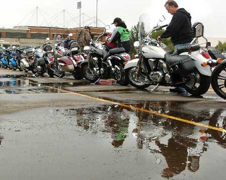 
                               
                                  Photo by Brooke McNeely&mdash;
                               
                           
                           Kawasaki representatives Dan Millholland, right, and C.J. Culley gas up demo bikes Tuesday as they prepare their booth for the beginning of Bikes, Blues & BBQ today at the Randal Tyson Track Center in Fayetteville. Bikers can stop by and try out the different bikes Kawasaki has to offer during the four-day rally.