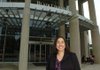 Shawna Thorup, the newly hired executive director of the Fayetteville Public Library, stands in front of the library Tuesday on Mountain Street. She takes over as executive director Oct. 31.