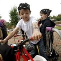 Zachary O'Connell, 4, climbs onto his tricycle Wednesday during the second annual Trikes, Blues & BB...