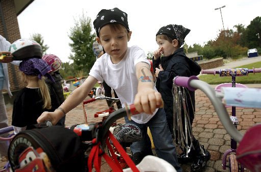 
                               
                                  Photo by Jason Ivester&mdash;
                               
                           
                           Zachary O'Connell, 4, climbs onto his tricycle Wednesday during the second annual Trikes, Blues & BBQ at the First School at First United Presbyterian Church in Fayetteville. The students were raising money for St. Jude Children's Hospital.