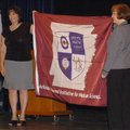 Heritage High School principal Karen Steen (left) and Superintendent Janie Darr hold flag that was p...