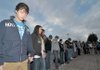 Bentonville sophomores Dylan Poe, left, and Ashton Dawson, second from left, led students in prayer during a See You at the Pole rally at Bentonville High School on Wednesday morning. 