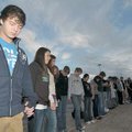 Bentonville sophomores Dylan Poe, left, and Ashton Dawson, second from left, led students in prayer ...
