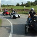 Larry Sherwin, right, tests out a Spyder roadster by Can-Am on Wednesday on Cato Springs Road in Gre...