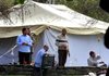 People gather around a tent Wednesday on the estate in Bedford, N.Y., owned by Donald Trump. The tent was later taken down.