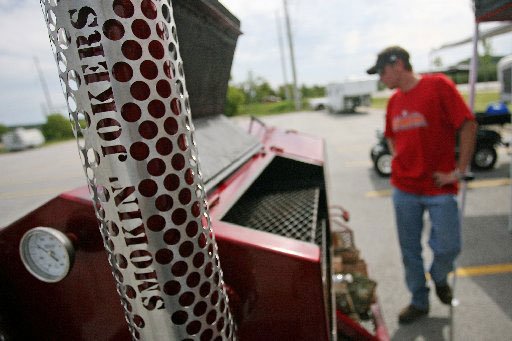 
                               
                                  Photo by William Moore&mdash;
                               
                           
                           Grant Loyd of Siloam Springs and the Smokin' Jokers explains his team's smoker in the parking lot across the road from Baum Stadium before the start of the bar-b-que competition for Bikes, Blues and BBQ Thursday, September 24, 2009 in Fayetteville. The Smokin' Jokers are from Alternative Design MFG. out of Siloam Springs.