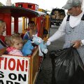 Maleah Gregrich,3, (center) of Gravette hugs a teddy bear while Kathy Blevins of Lowell (left) watch...