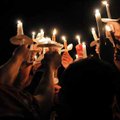 Members of the Gravette High School football team lifted up their candles while they said a prayer a...