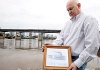 William Stevens holds a copy of a print of the Lizzie Simmons, a riverboat converted into a Confederate gunboat during the Civil War and renamed the Pontchartrain. 