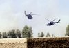 A U.S. military medivac helicopter (left) is escorted by a second helicopter Friday as it lifts off after picking up a Marine wounded in a firefight in Afghanistan's Nawa district.