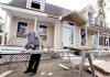 Builder Jean Gagnon cuts siding panels while completing a house earlier this week in Derry, N.H.