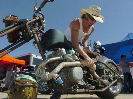 
                               
                                  Photo by Michael Woods&mdash;
                               
                           
                           Shannon "Shoe" Gower with Hotshoe Custom Motorcycle, Inc. in Locust Grove, Oklahoma shows off one of his bikes at his booth set up in the parking lot at Baum Stadium in Fayetteville for the 10th annual Bikes, Blues & BBQ in Fayetteville. 